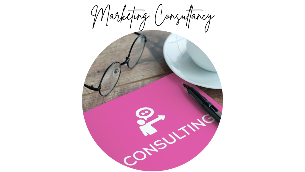 Pink notepad with consultancy written and a cup of coffee