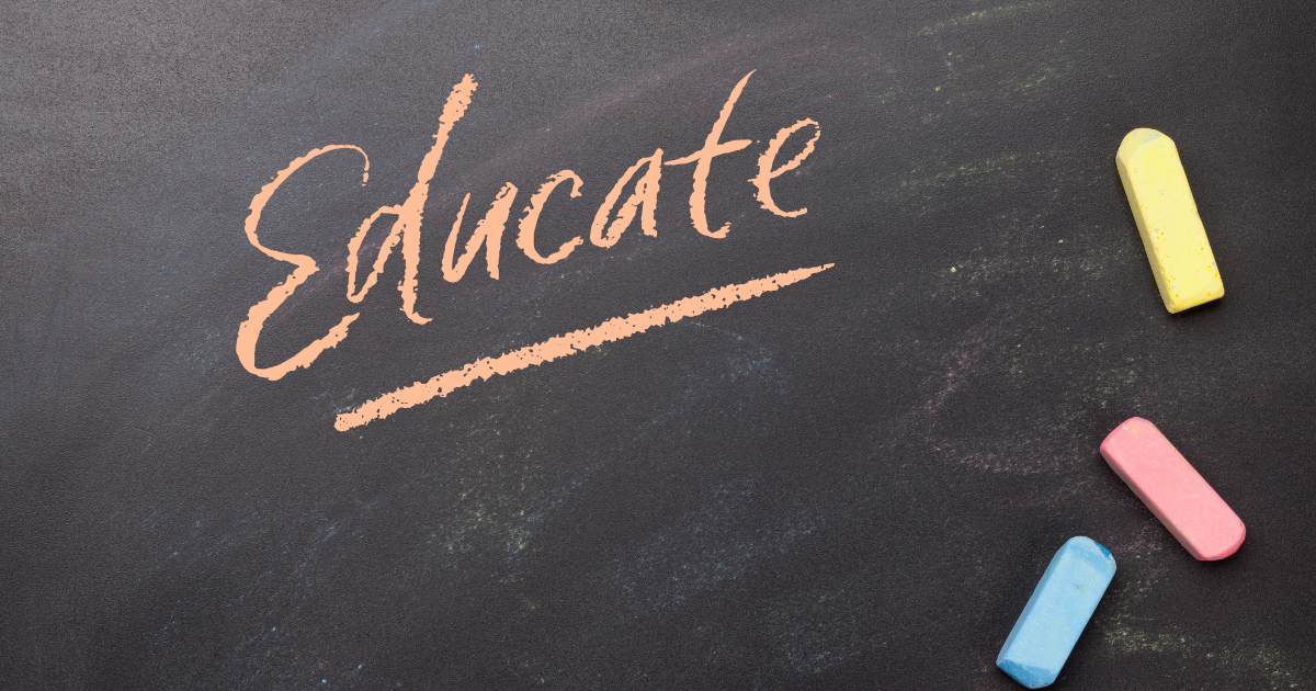 The word Educate written on a blackboard in orange chalk, cocktail creative